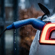 Electric car charging cable connected to a vehicle in the rain


