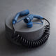 Spiral Type 2 charging cable with blue connectors on a concrete studio pedestal