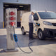 Driver charging a white electric van from a red CEE power pillar with a Voldt® cable