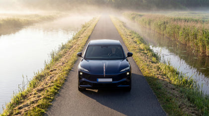 Dark blue Hongqi EHS7 electric SUV on a misty countryside road